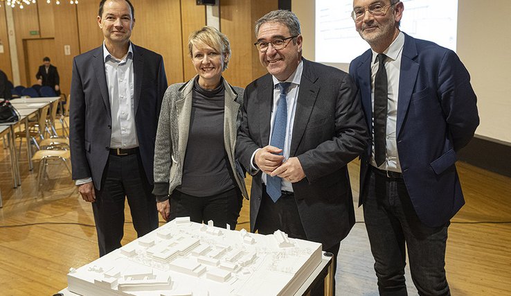 photo de groupe devant la maquette du gymnase