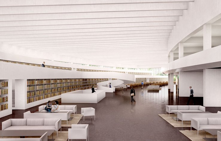 Une longue salle avec des sièges et des rangées de livres, un escalier et une coursive.