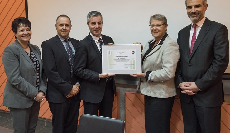 Les personnages posent en tenant le diplôme officiel.