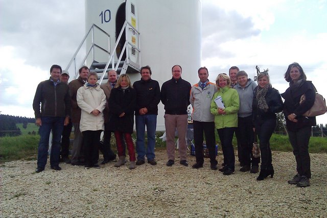 Le Conseil d'Etat au pied d'une éolienne, avec le portillon d'accès ouvert.