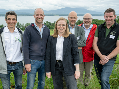 Les personnages posent côte à côte à l'extérieur.