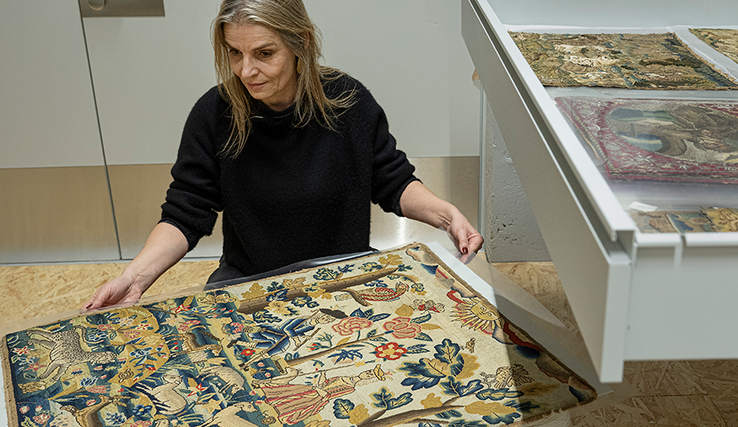 Magali Junet, conservatrice de la collection Toms Pauli, extrait cette pièce chamarrée, brodée au petit point par une main anonyme dans l’Angleterre de 1710. Photo | ARC-Sieber