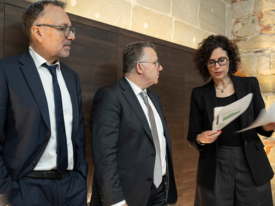 Les personnes après la conférence de presse. Madame Luisier tient un dossier de presse.